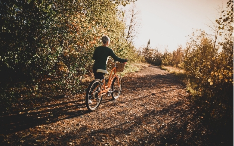 girl riding bike along path